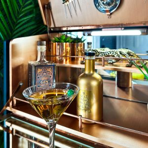 Art Deco cocktail cabinet copper interior with mirrored shelf and bar accessories featuring the 'Bijou' Cocktail